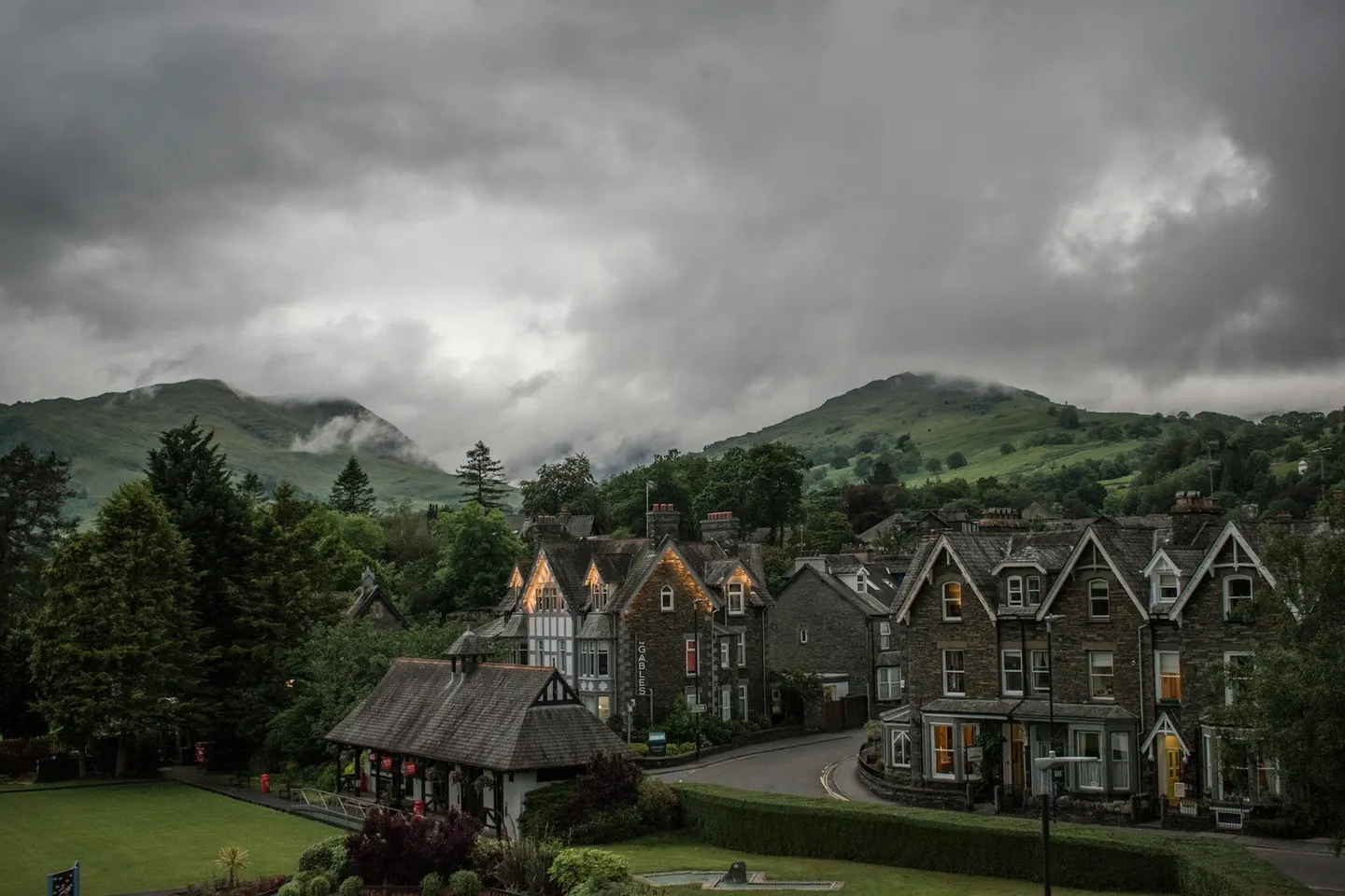 Photo of Ambleside, Cumbria — Stone houses on the edge of town beneath cloud-capped fells.
