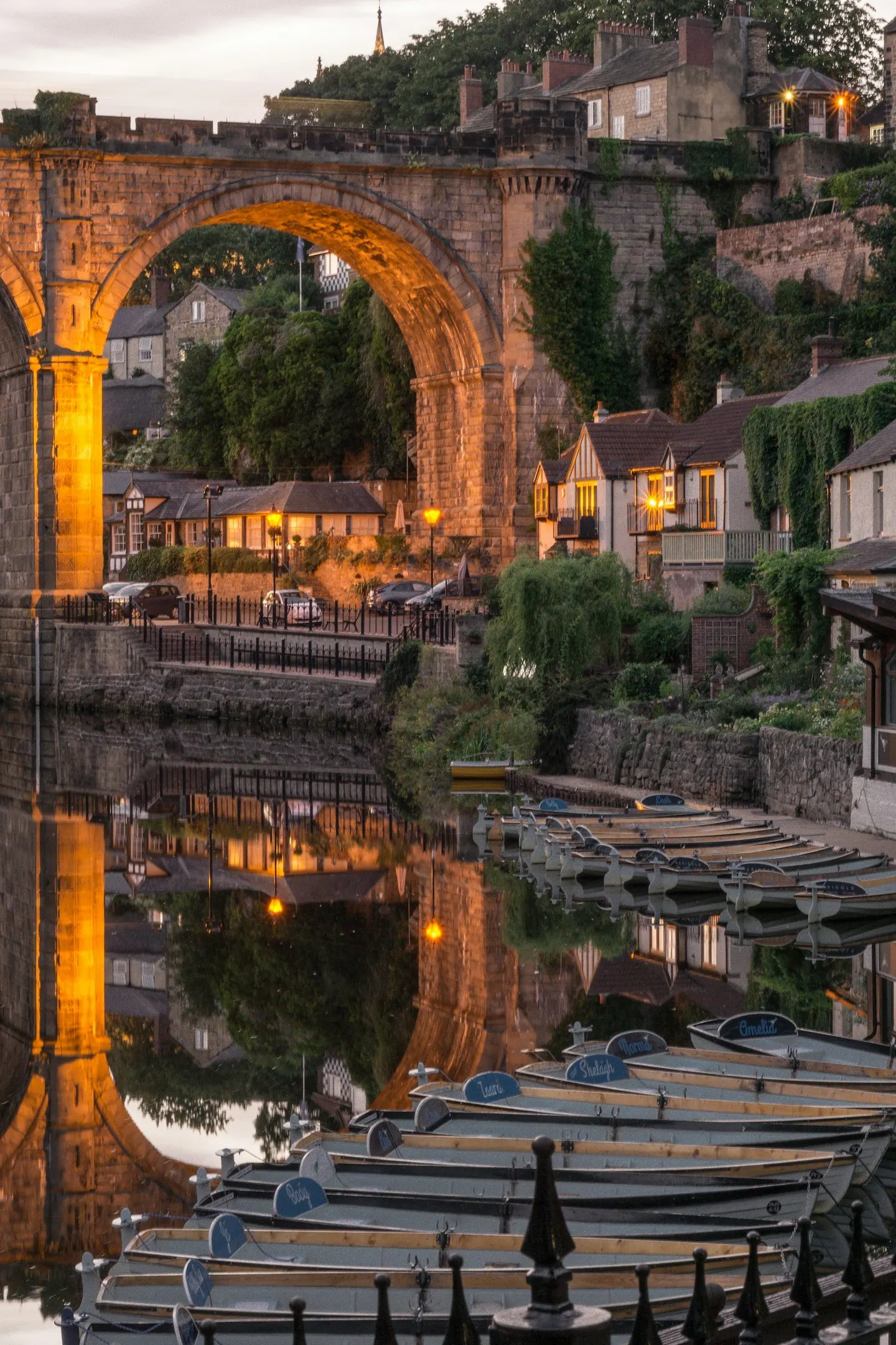 Photo of Knaresborough, North Yorkshire — Rowing boats on the Nidd below the railway viaduct at dusk.