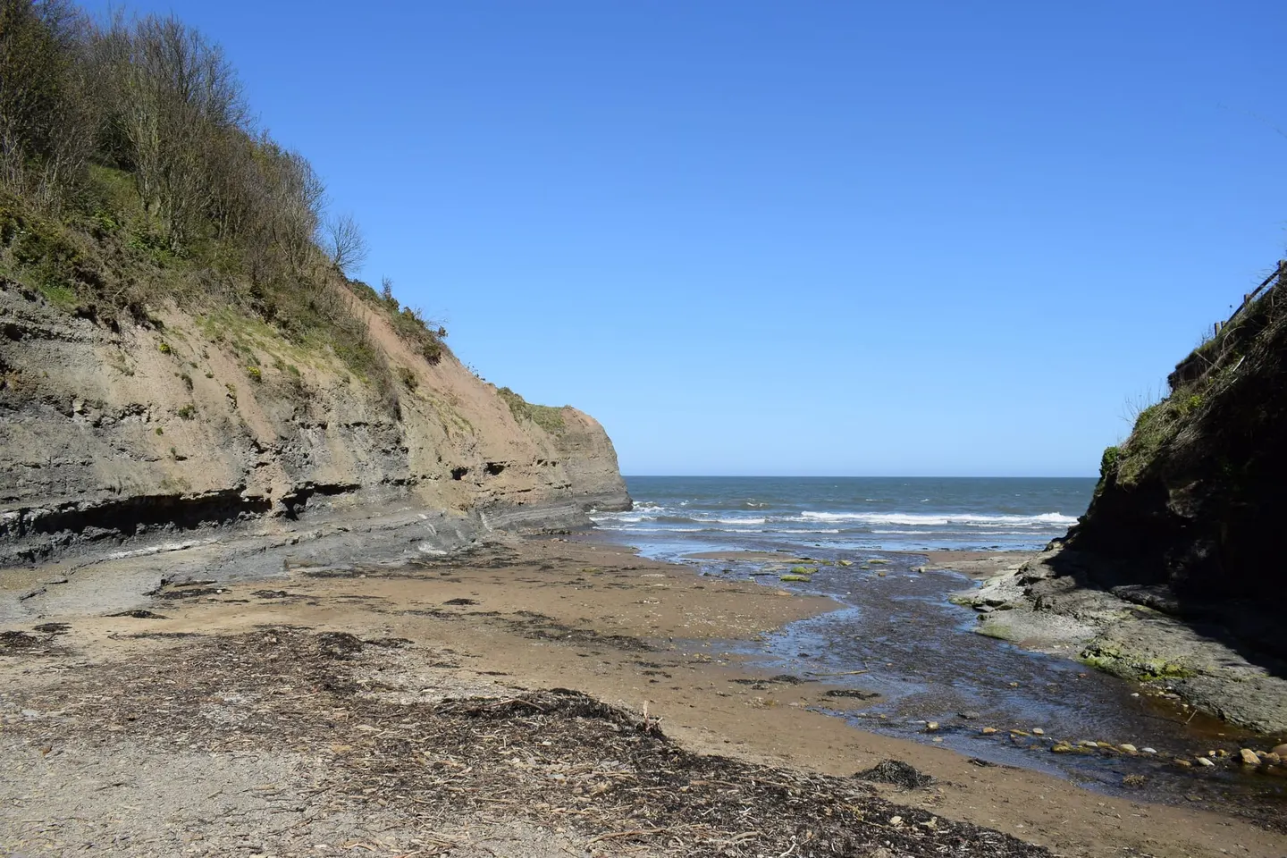Photo of Boggle Hole, a cove near Robin Hood's Bay in the North York Moors, North Yorkshire, northern England.