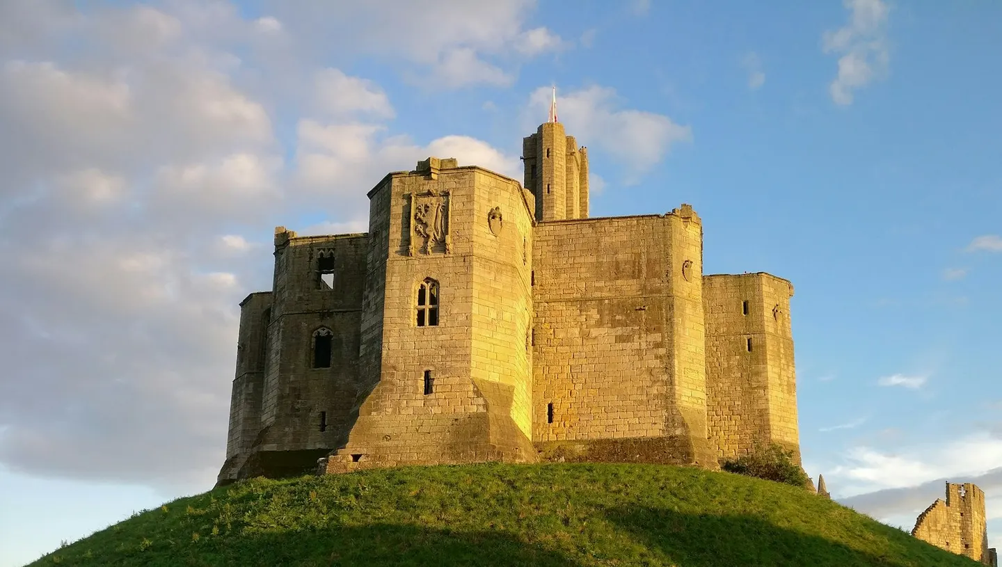 Photo of Warkworth Castle, a ruined castle in Northumberland, north east England.