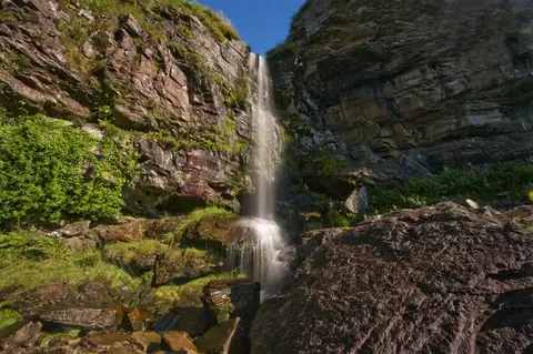 Photo of Penpych Waterfall, a waterfall near Pontneddfechan, Rhondda Cynon Taf, south east Wales.