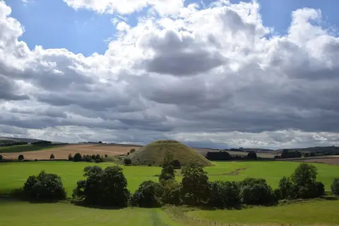 Photo of Silbury Hill, a prehistoric mound near Avebury in the North Wessex Downs, Wiltshire, south west England.