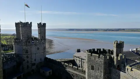 Photo of Caernarfon Castle, a ruined castle near Newborough, Gwynedd, north Wales.