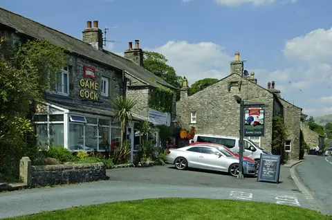 Photo of The Game Cock Inn, a pub near Austwick in the Yorkshire Dales, North Yorkshire, northern England.