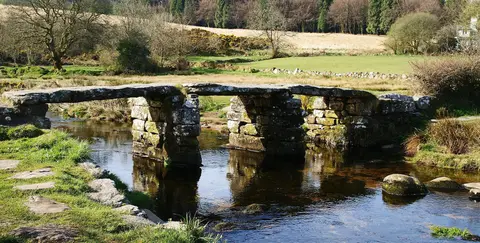 Photo of Postbridge Clapper Bridge, a landmark in Dartmoor, Devon, south west England.