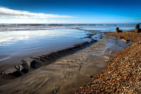 Photo of Camber Sands, a swimming spot near Rye, East Sussex, south east England.
