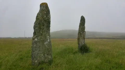 Photo of Penrhosfeilw Standing Stones, a standing stone near Holyhead, Anglesey, north Wales.