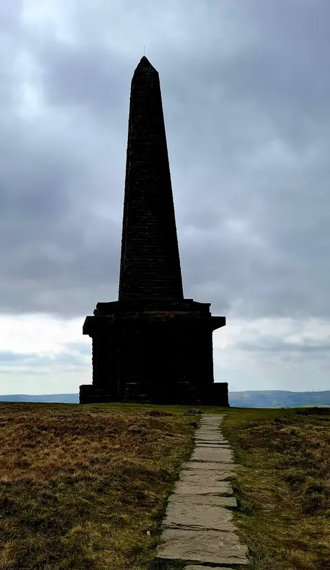 Photo of Stoodley Pike Monument, a landmark near Cragg Vale, West Yorkshire, northern England.